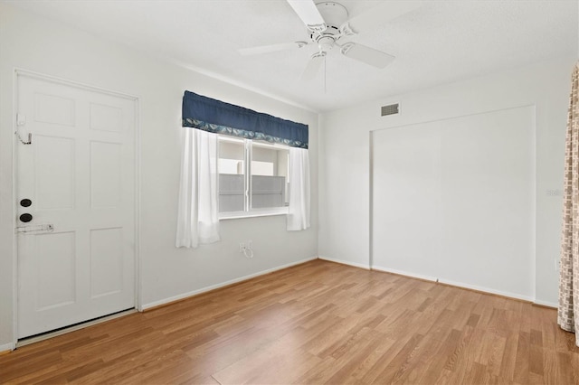 unfurnished bedroom featuring wood finished floors, visible vents, and baseboards