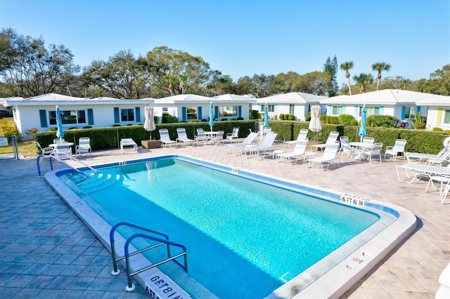 view of pool with fence and a patio