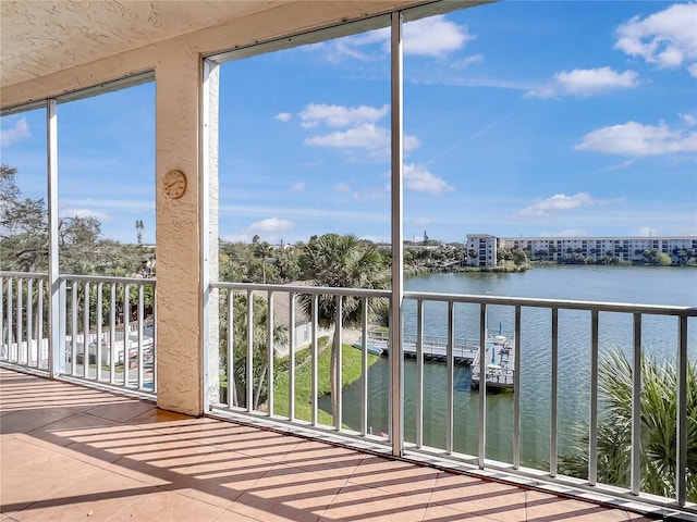 unfurnished sunroom featuring a water view