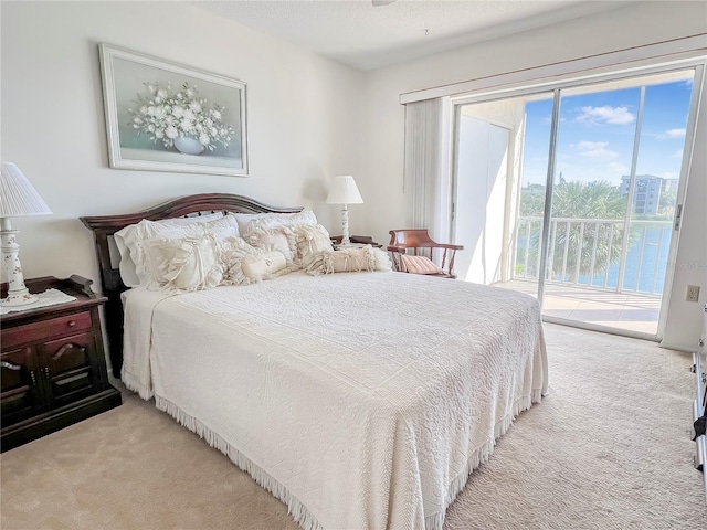 bedroom featuring a textured ceiling, carpet floors, and access to exterior