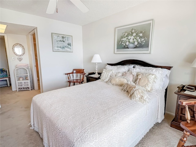 bedroom with carpet flooring, ceiling fan, and a textured ceiling