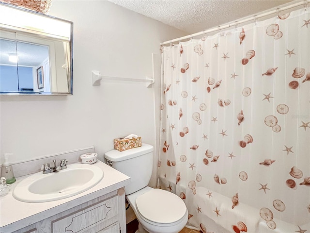 bathroom with a textured ceiling, shower / bath combo, vanity, and toilet