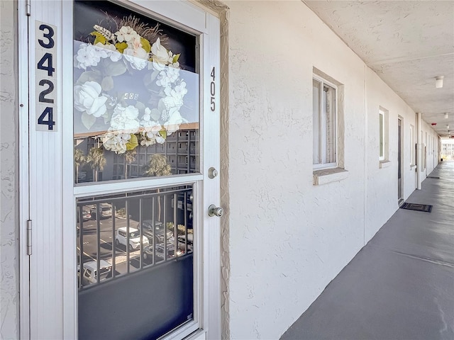 entrance to property with stucco siding