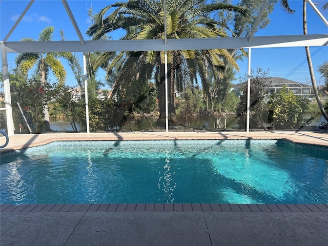 outdoor pool with a lanai and a patio area