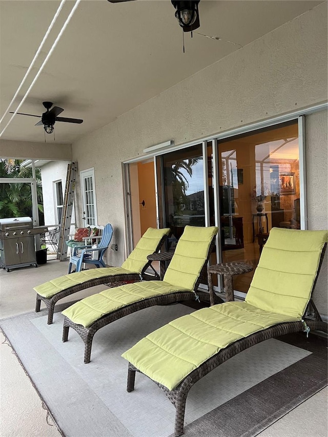 view of patio with area for grilling and a ceiling fan