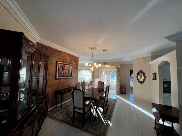 dining space featuring light tile patterned floors, ornamental molding, baseboards, and a notable chandelier