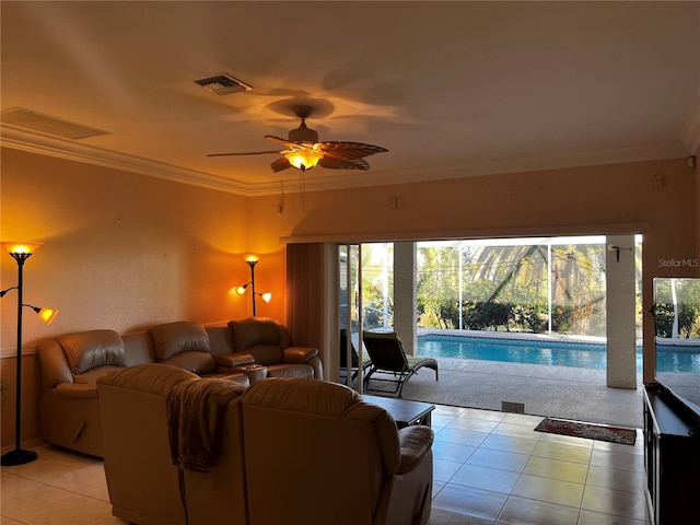 living room with ornamental molding, visible vents, ceiling fan, and light tile patterned floors