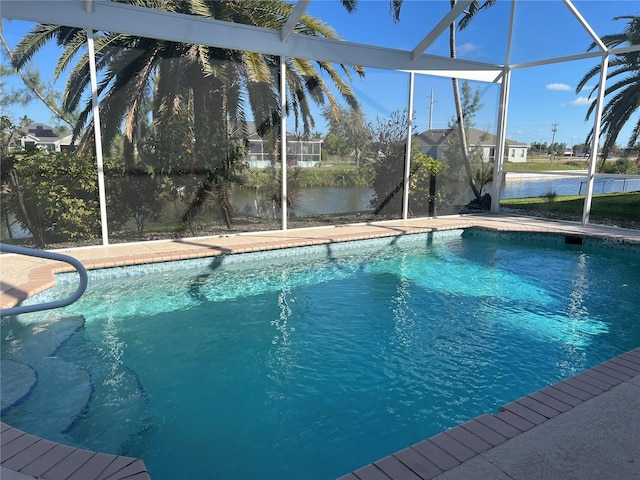 pool featuring a lanai, a water view, and a patio