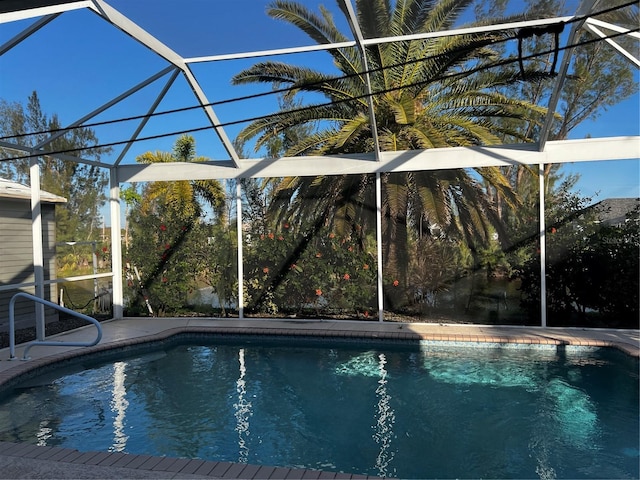 outdoor pool with glass enclosure and a patio