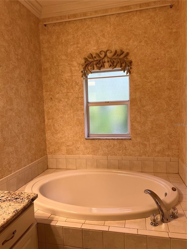 bathroom featuring ornamental molding, a garden tub, vanity, and wallpapered walls