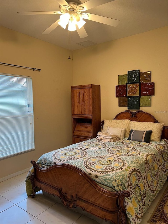 bedroom featuring light tile patterned floors, ceiling fan, and baseboards