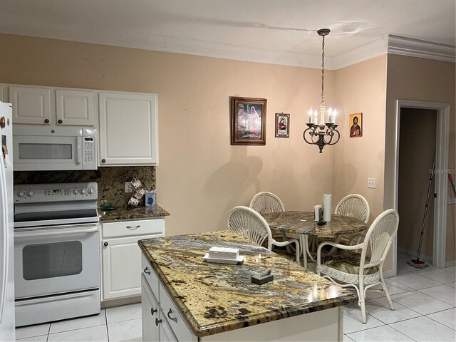 kitchen with white appliances, white cabinets, decorative backsplash, ornamental molding, and dark stone countertops