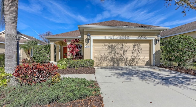 single story home featuring a garage, concrete driveway, and stucco siding