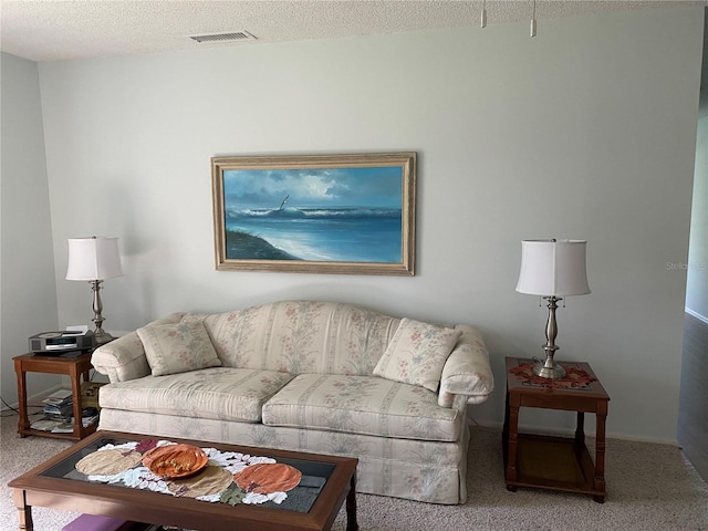 living area featuring a textured ceiling, carpet, and visible vents