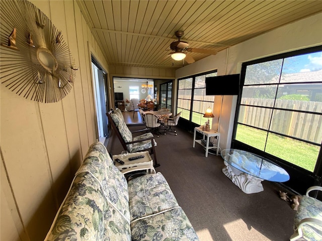 sunroom / solarium with wooden ceiling and a ceiling fan