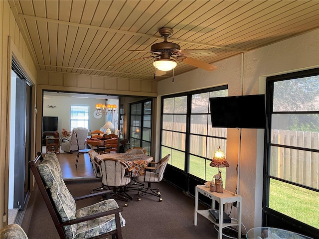 sunroom / solarium with wooden ceiling and ceiling fan with notable chandelier