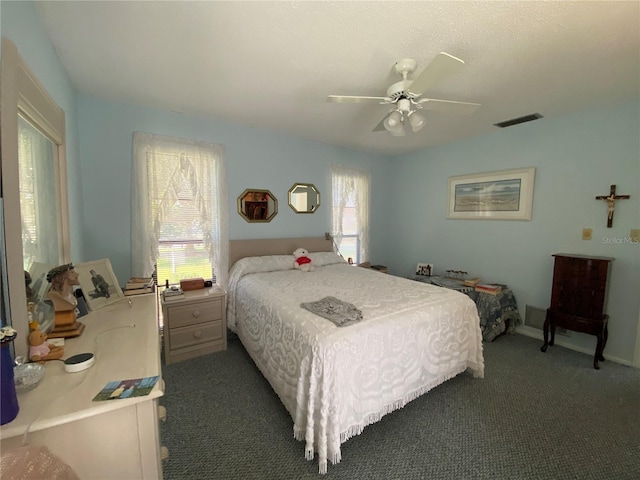 carpeted bedroom featuring visible vents and ceiling fan