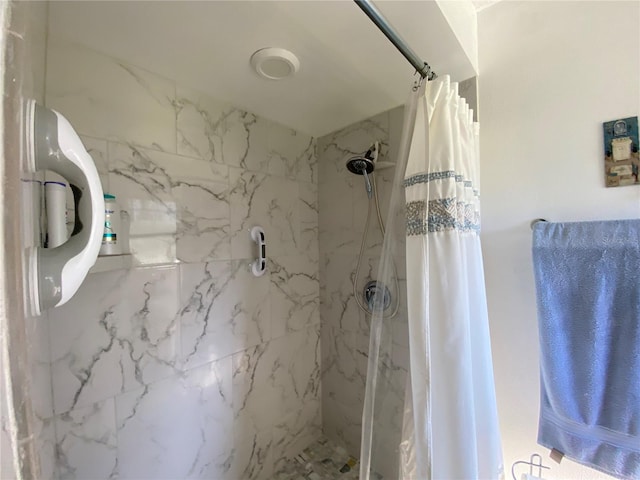 full bath with a marble finish shower