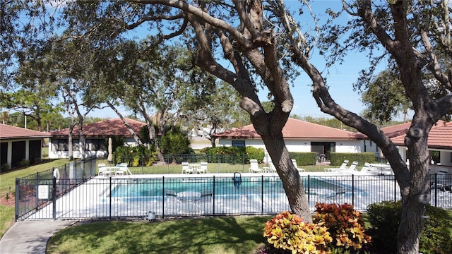 pool with a yard, a patio, and fence