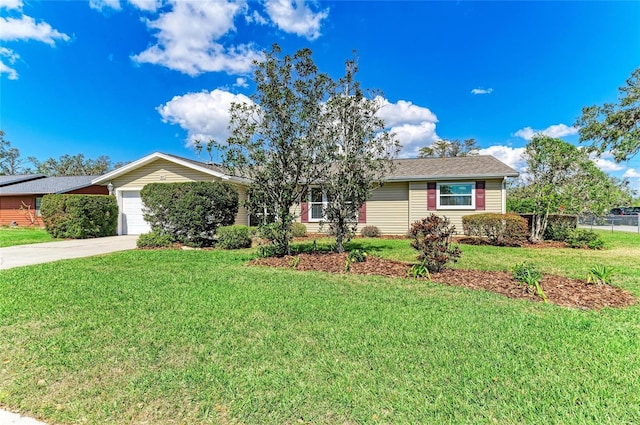 ranch-style home with a garage, a front lawn, and concrete driveway