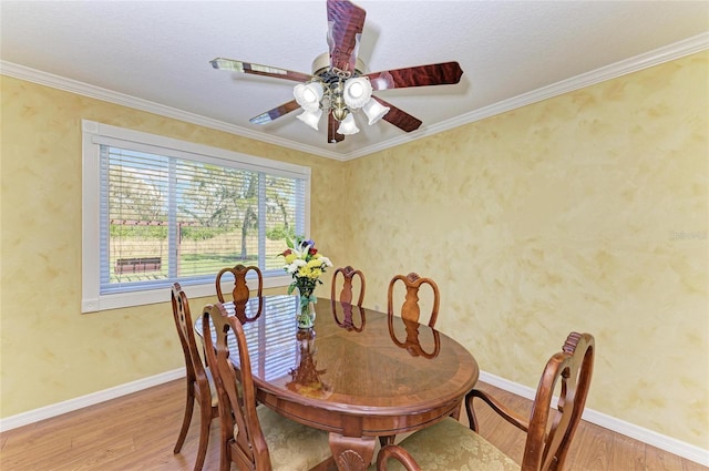 dining room with ornamental molding, light wood-type flooring, and baseboards