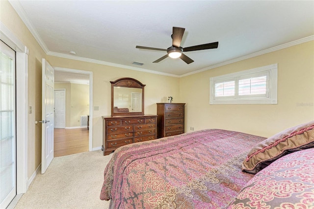 bedroom with crown molding, carpet floors, visible vents, and baseboards