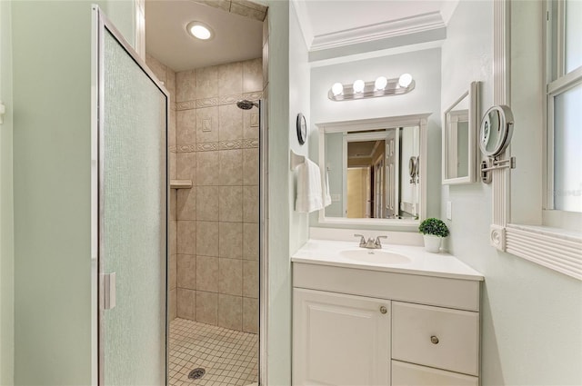 bathroom featuring a shower stall, crown molding, and vanity