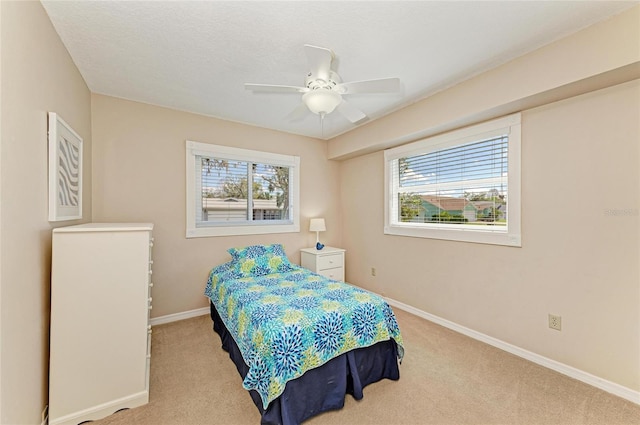 bedroom with carpet floors, baseboards, and a ceiling fan