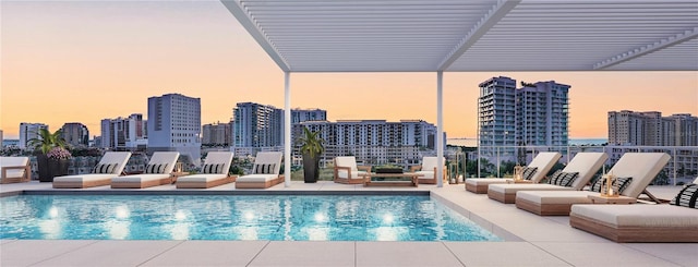 1305 4th St Unit 202P, Sarasota, FL 34236 - pool at dusk featuring a community pool and a skyline view
