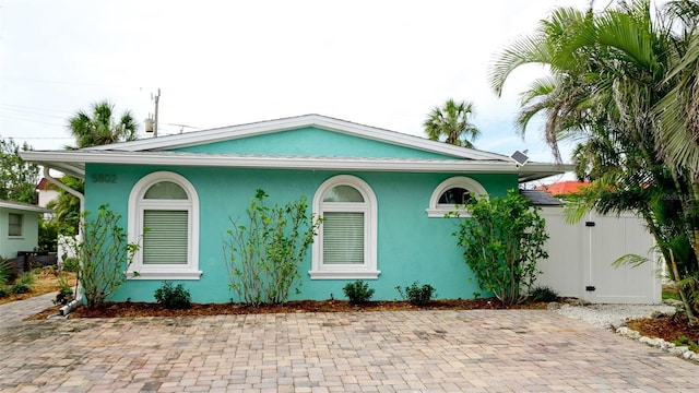 view of home's exterior featuring fence and stucco siding