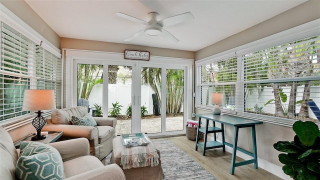 sunroom / solarium featuring ceiling fan