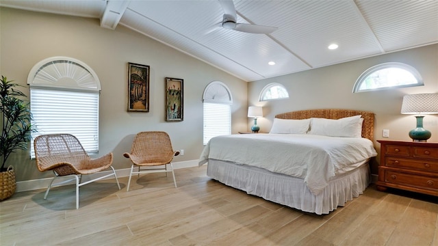 bedroom with light wood finished floors, a ceiling fan, lofted ceiling with beams, and baseboards