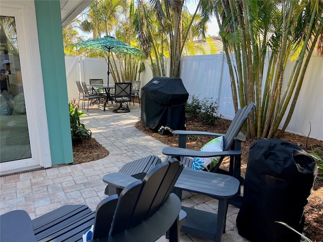 view of patio / terrace with area for grilling, a fenced backyard, and outdoor dining space