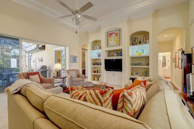 7762 US Open Loop, Lakewood Ranch, FL 34202 - living area with arched walkways, crown molding, built in shelves, ceiling fan, and recessed lighting