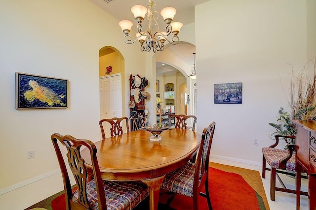 7762 US Open Loop, Lakewood Ranch, FL 34202 - dining area with arched walkways, a chandelier, and baseboards