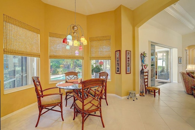 7762 US Open Loop, Lakewood Ranch, FL 34202 - tiled dining area with a chandelier, healthy amount of natural light, and baseboards