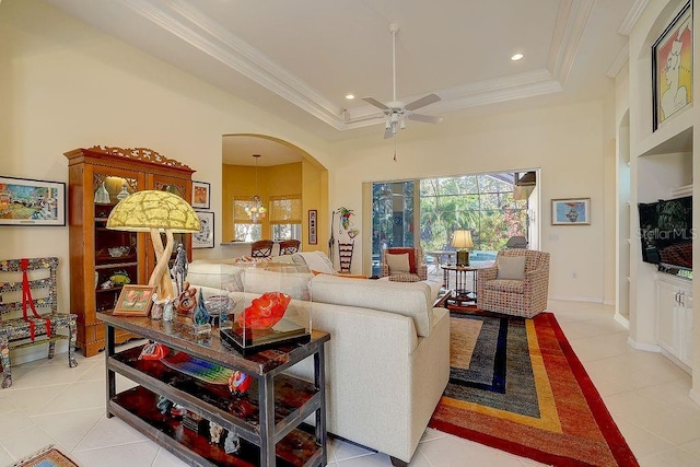 7762 US Open Loop, Lakewood Ranch, FL 34202 - living area featuring a tray ceiling, a ceiling fan, arched walkways, light tile patterned floors, and ornamental molding