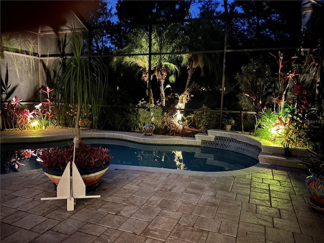 7762 US Open Loop, Lakewood Ranch, FL 34202 - pool at night featuring an outdoor pool, a lanai, and a patio area