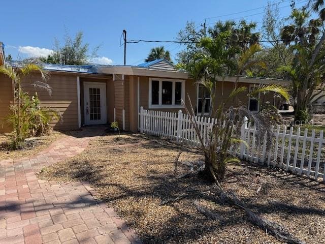 ranch-style home with a fenced front yard