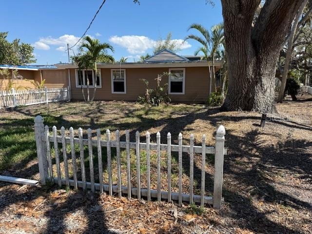 ranch-style home featuring fence