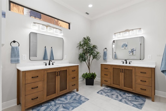 full bath featuring ornamental molding, two vanities, and a sink