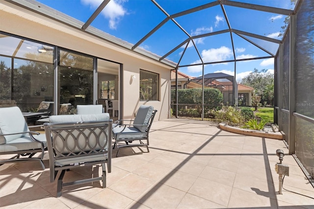 view of patio featuring a lanai