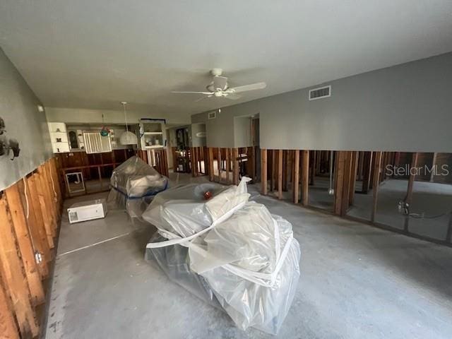 interior space with concrete flooring, ceiling fan, and visible vents