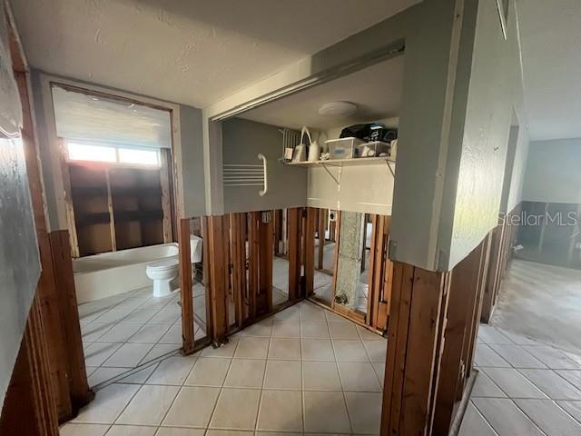 hallway featuring light tile patterned floors