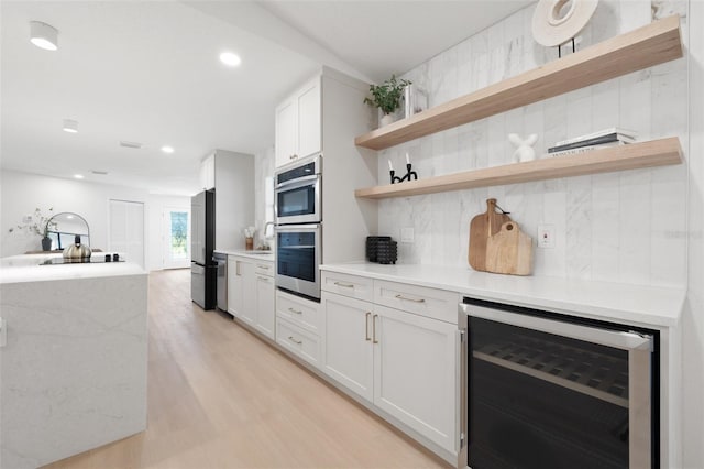 kitchen featuring wine cooler, stainless steel appliances, decorative backsplash, open shelves, and light wood finished floors