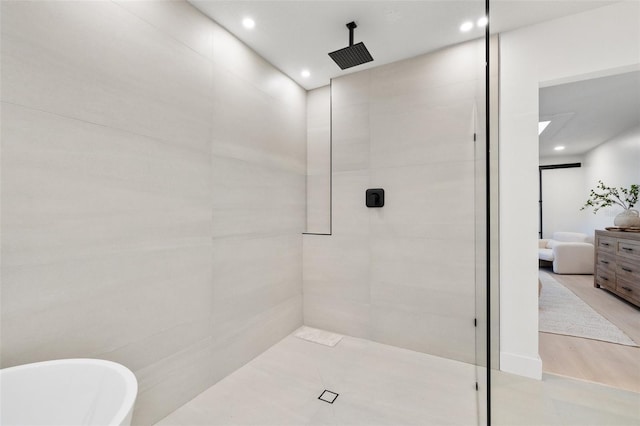 full bath featuring recessed lighting, a tile shower, a freestanding bath, and ensuite bath