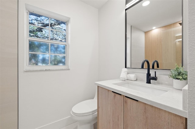 bathroom with vanity, toilet, and recessed lighting