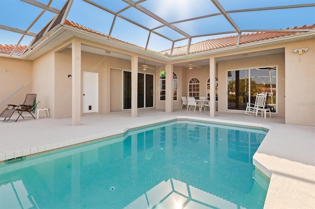4173 Hearthstone Dr, Sarasota, FL 34238 - rear view of property featuring ceiling fan, a patio area, stucco siding, and an outdoor pool