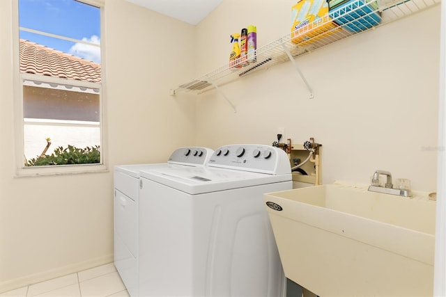 4173 Hearthstone Dr, Sarasota, FL 34238 - clothes washing area featuring independent washer and dryer, baseboards, light tile patterned floors, a sink, and laundry area