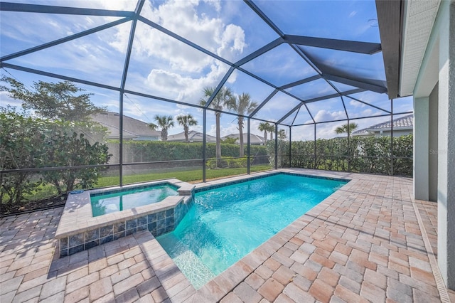 view of pool featuring a patio, a pool with connected hot tub, and a lanai